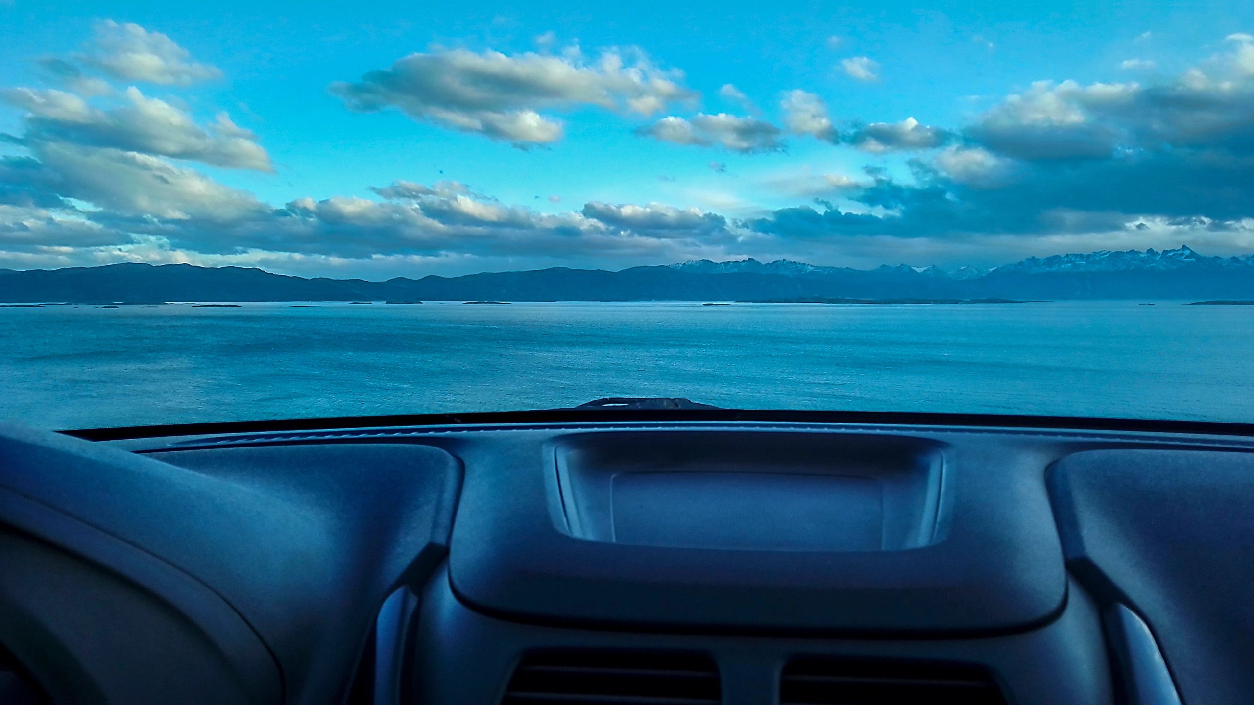 Road view from inside a vehicle representing connected driving platforms