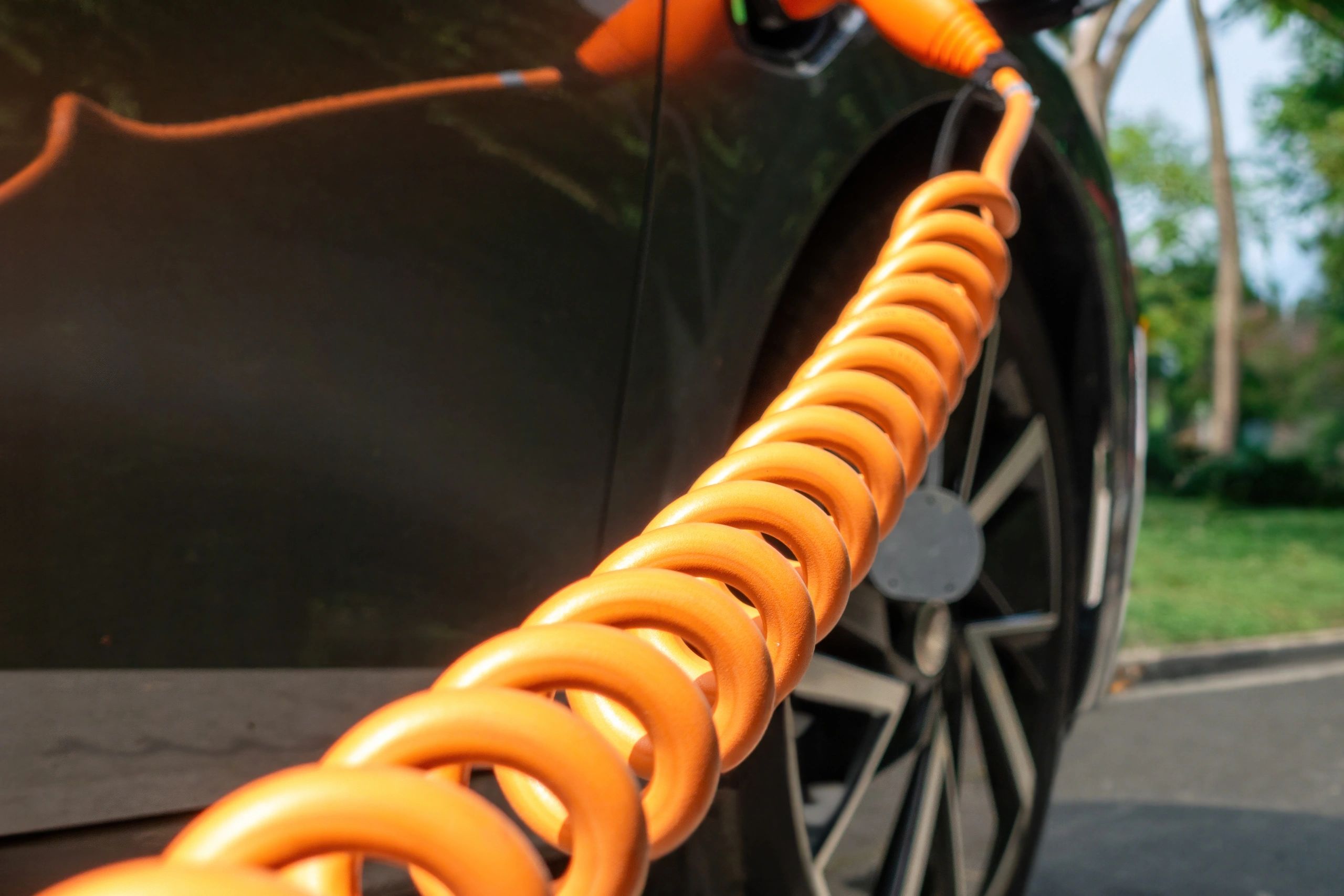 Electric vehicle charging cable connected to a vehicle