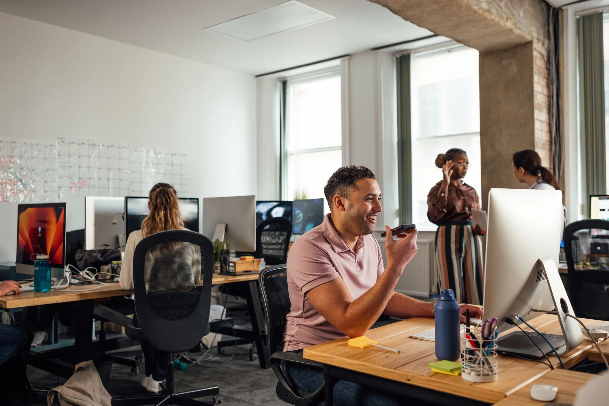 Automotive technology team collaborating in a modern office